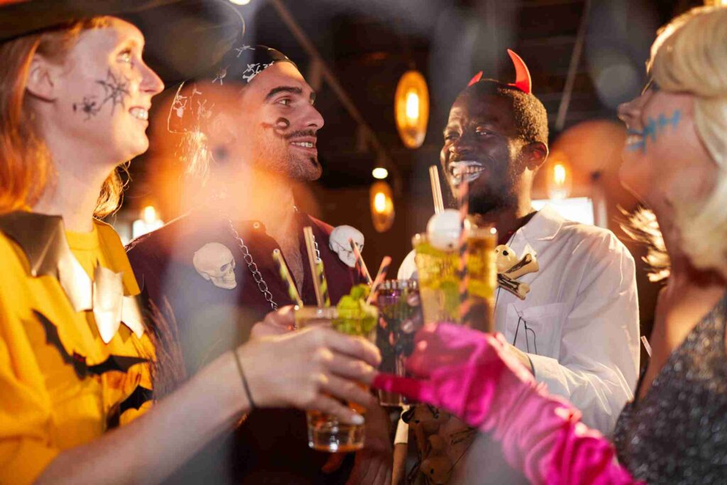 Friends dressed in colorful costumes gather for a festive celebration at Plume in Houston, TX.